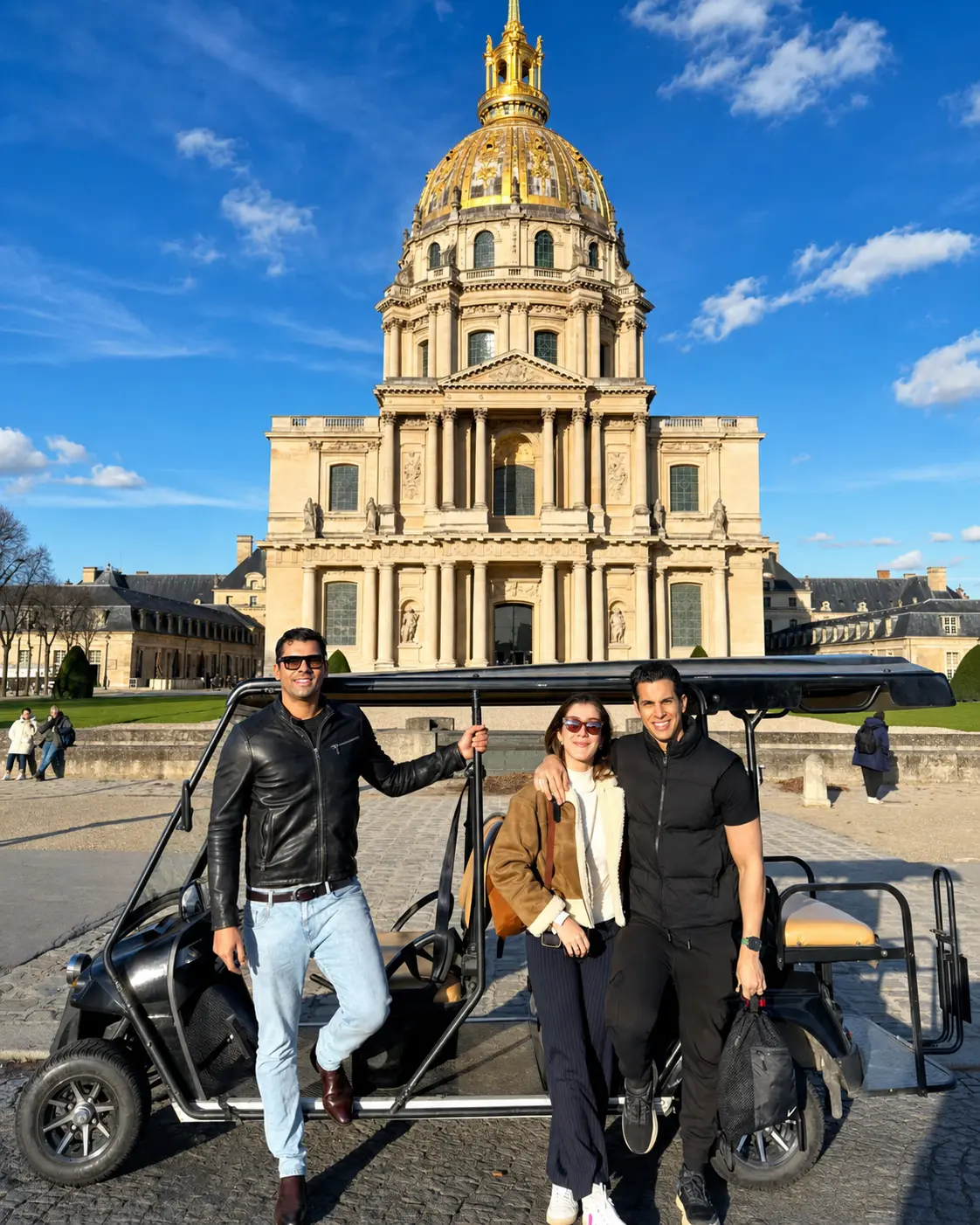 Happy clients posing after a private electric golf cart tour in Paris near Les Invalides