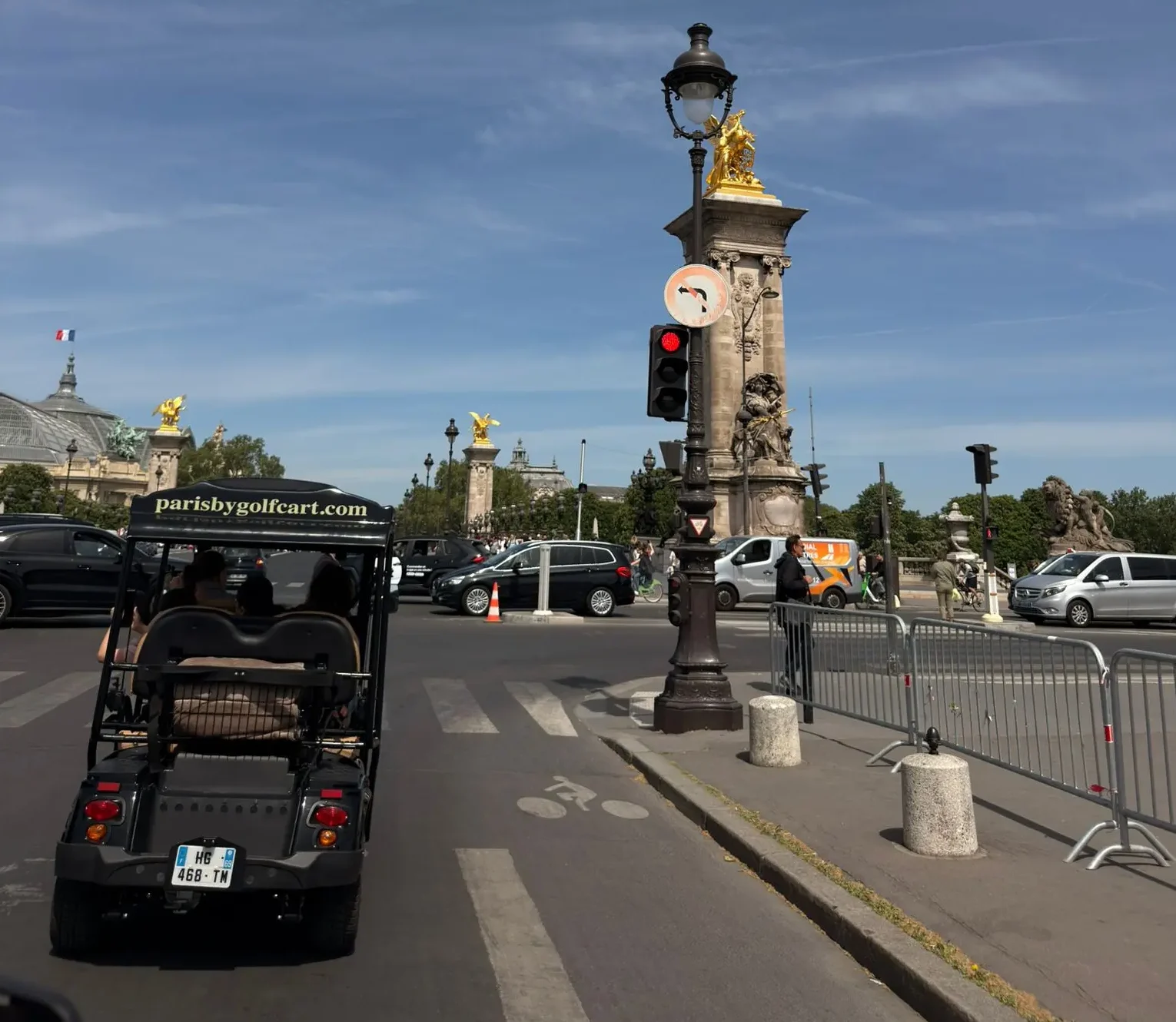 Private golf cart stopped in front of the Louvre glass pyramid in Paris
