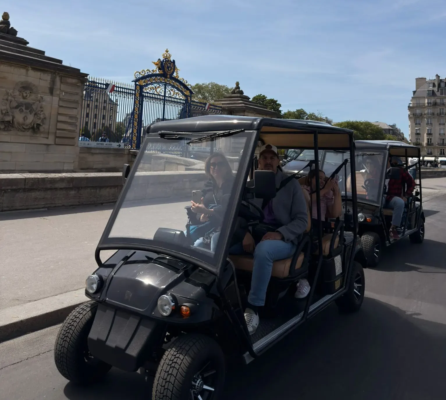 Travelers enjoying iconic Paris views from a private golf cart near the Eiffel Tower